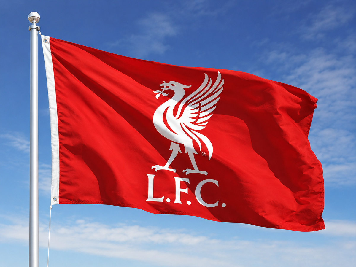 A red Liverpool Football Club flag with the white Liverbird crest and 'L.F.