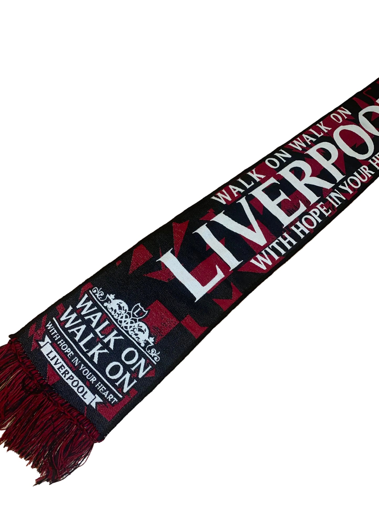 A black and red knit scarf with white text reading 'WALK ON WALK ON LIVERPOOL WITH HOPE IN YOUR HEART' and 'LIVERPOOL 1892', laid out diagonally on a wooden floor.