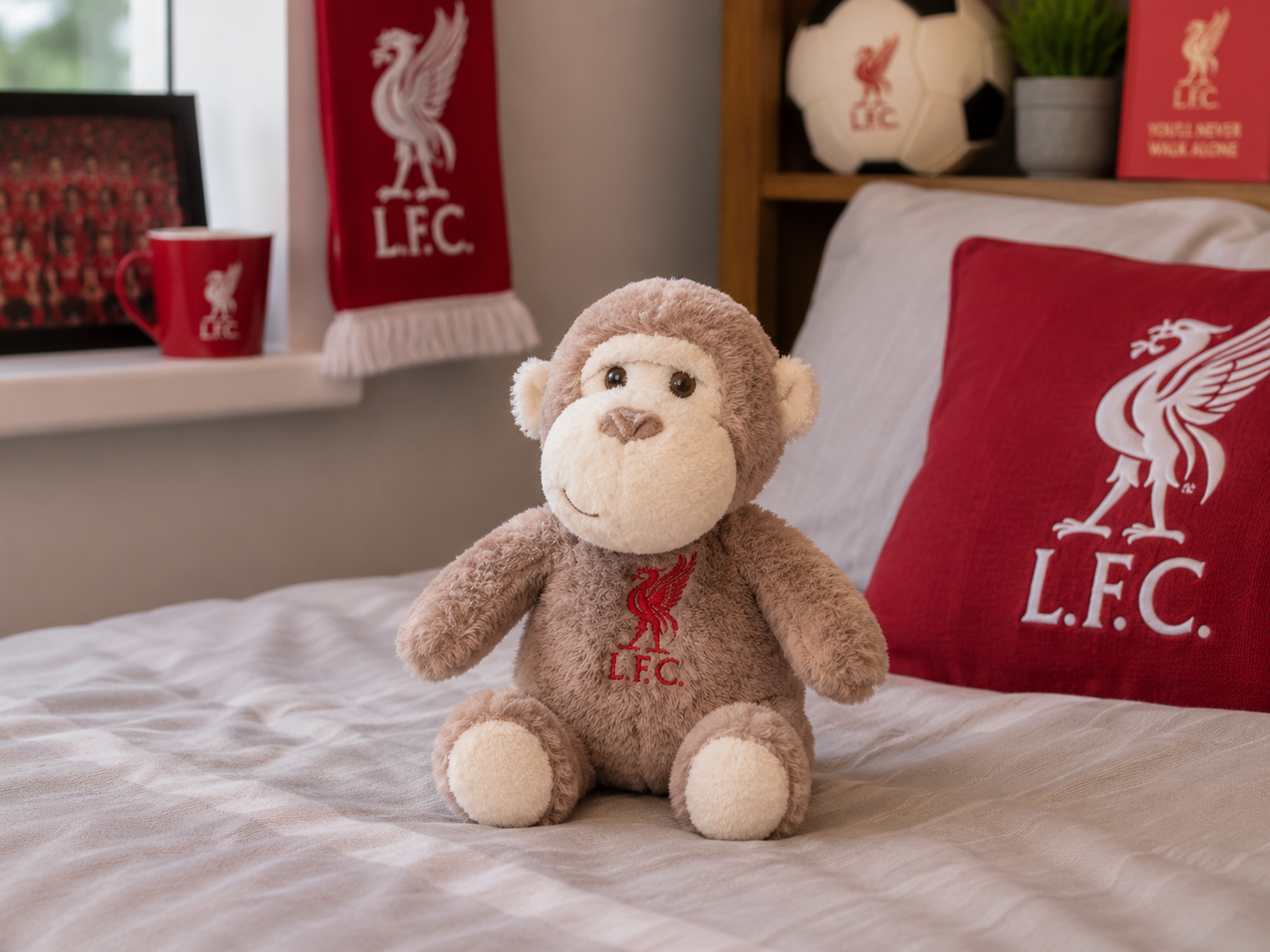 A brown plush monkey toy with Liverpool Football Club (L.F.