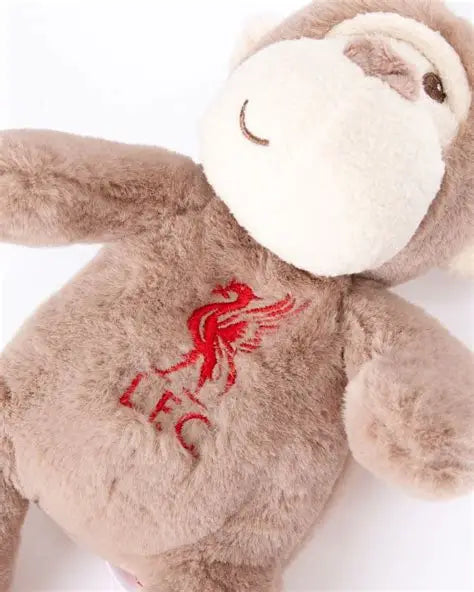 A plush monkey toy in light brown and cream, featuring a red embroidered Liverpool FC bird crest and 'LFC' text on its chest, shown against a plain white background.