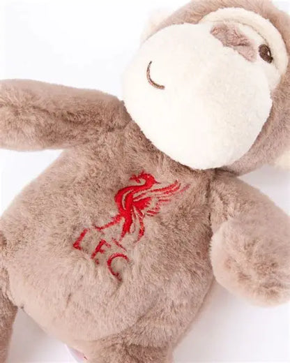 A plush monkey toy in light brown and cream, featuring a red embroidered Liverpool FC bird crest and 'LFC' text on its chest, shown against a plain white background.